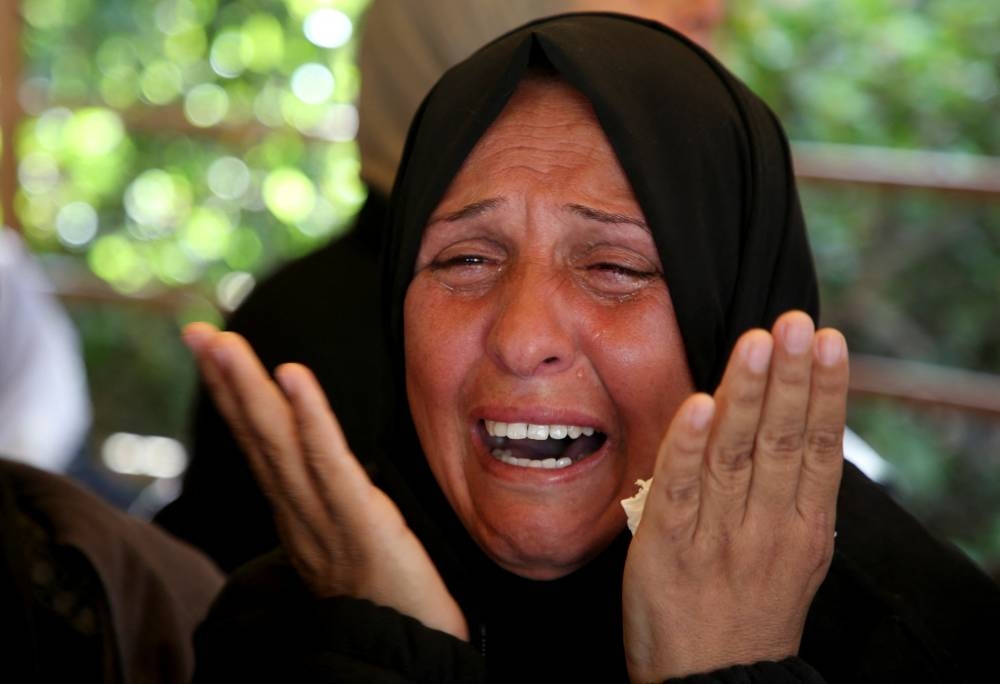 A woman reacts during the funeral of Palestinian Anas Al-Masri, who succumbed to wounds sustained from an Israeli strike, in Khan Younis in the southern Gaza Strip, on Tuesday. REUTERS