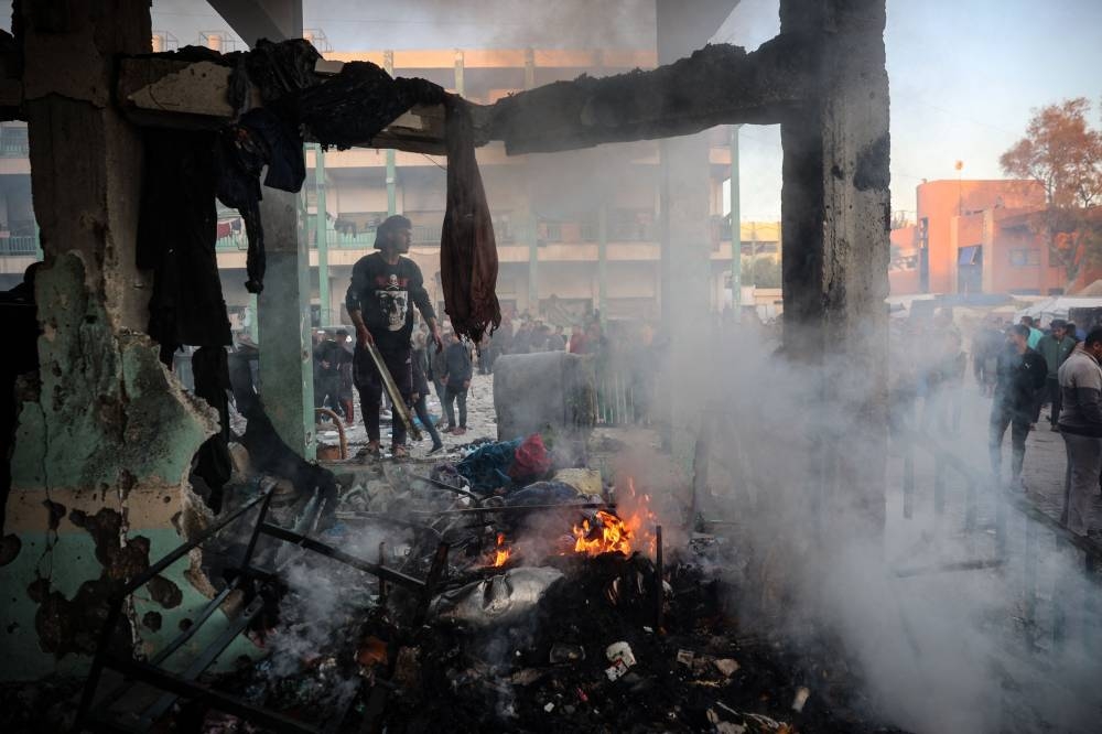 A fire burns amid the debris following an Israeli strike that hit a UN-run school where people had taken refuge, in the Nusseirat refugee camp in the central Gaza Strip on Wednesday. AFP
