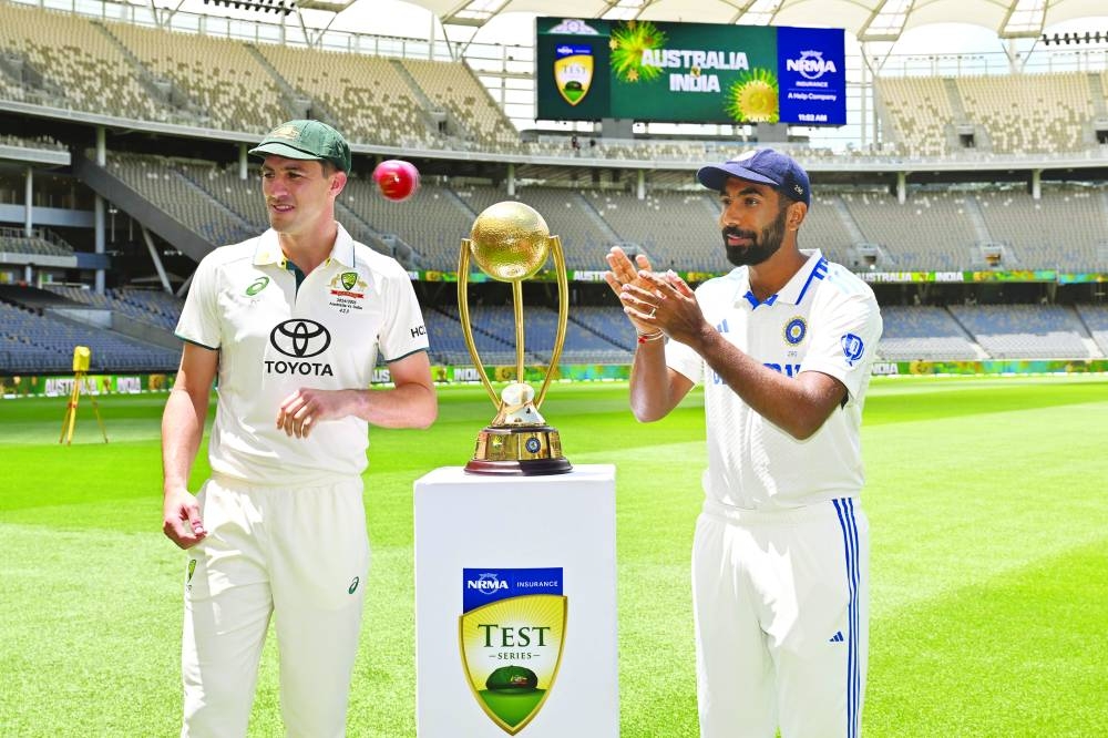 Australia captain Pat Cummins (left) and India captain Jasprit Bumrah pose with the trophy at Optus Stadium in Perth on Thursday, on the eve of the first Test of the five-Test Border-Gavaskar Trophy. (AFP)