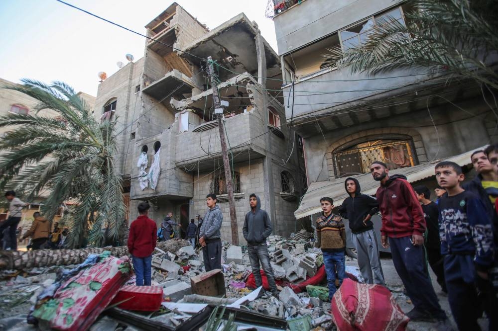 People check the site on an Israeli strike at a house in Nuseirat in the central Gaza Strip on Friday. AFP