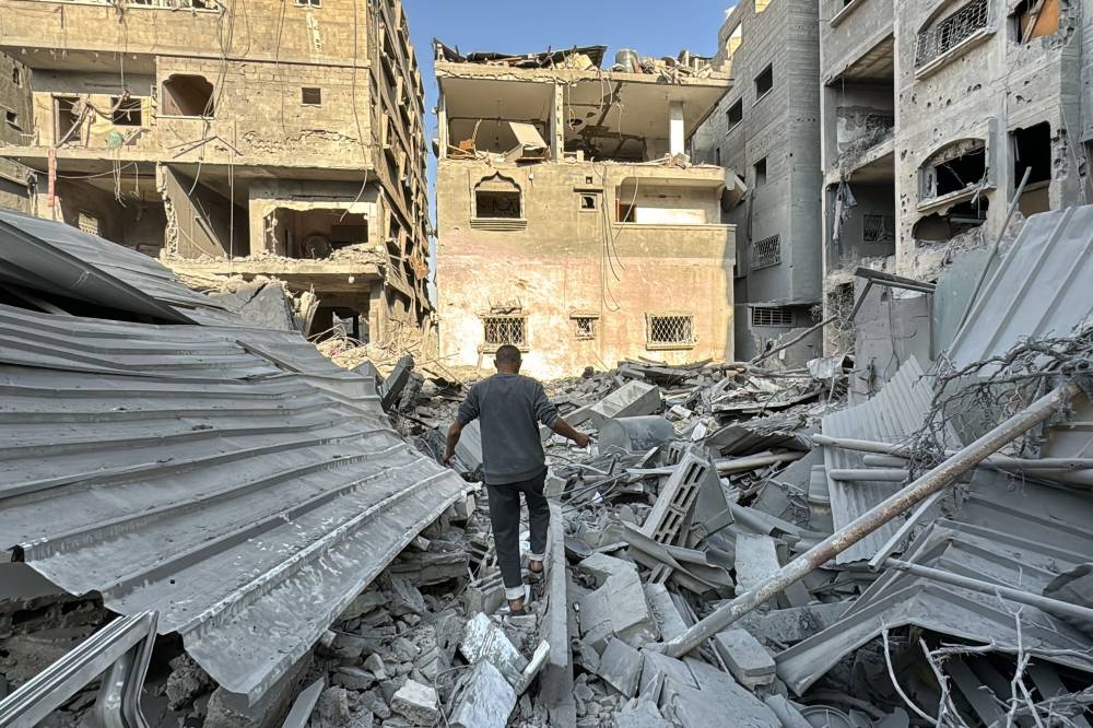 A Palestinian inspects the rubble of a building in Beit Lahia, in the northern Gaza Strip, on Thursday. AFP