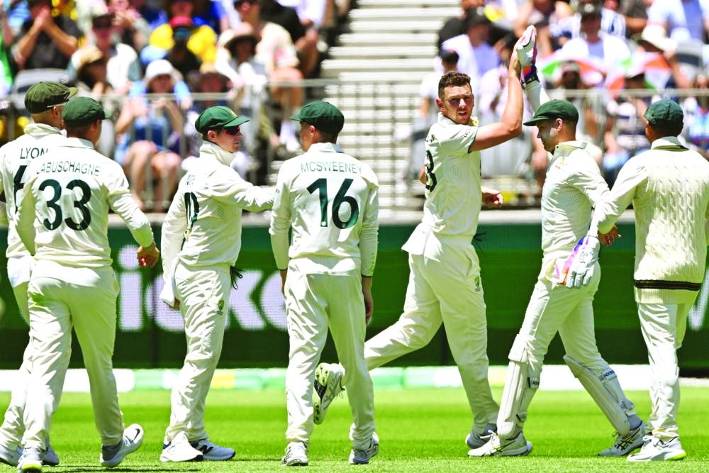 Australia’s paceman Josh Hazlewood (third right) celebrates his wicket of India’s Virat Kohli with teammates on Friday. (AFP)