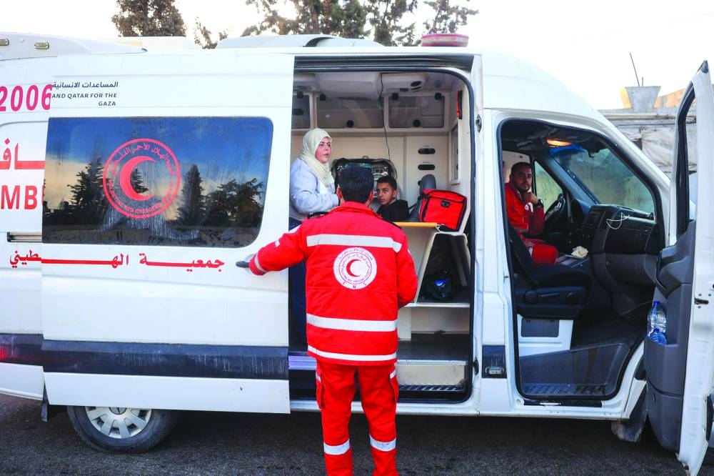 Medics of the World Health Organisation and the Palestinian Red Crescent prepare to start a convoy from the European Hospital in Khan Yunis south of Gaza, evacuating some patients and war-wounded from the besieged Palestinian territory.