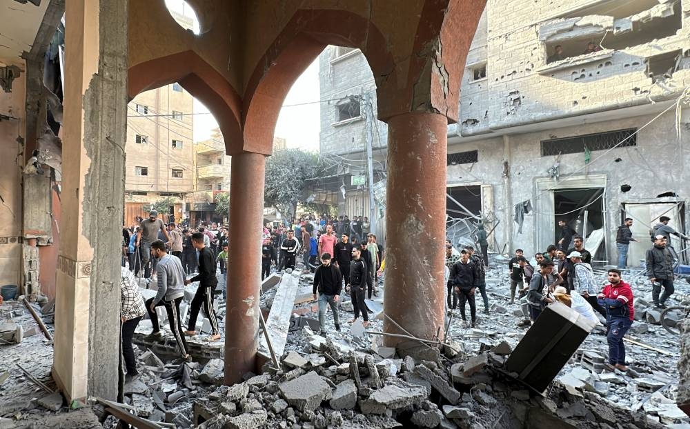 Palestinians inspect the site of an Israeli strike on Al-Farooq mosque, amid the Israel-Hamas conflict, in Nuseirat refugee camp, in the central Gaza Strip, on Saturday. REUTERS
