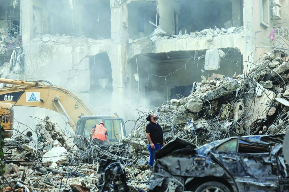 Civil defence members and rescuers work at the site of an Israeli strike in Beirut’s Basta neighbourhood, amid the ongoing hostilities between Hezbollah and Israeli forces, in Lebanon, yesterday.