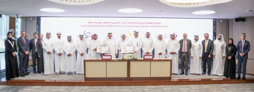 Commercial Bank and Qatar Post executives with HE Abdul Rahman bin Hamad al-Attiyah and  Faleh bin Mohammed al-Naemi at the unveiling of the first special edition post stamps in celebration of the bank's 50th anniversary.