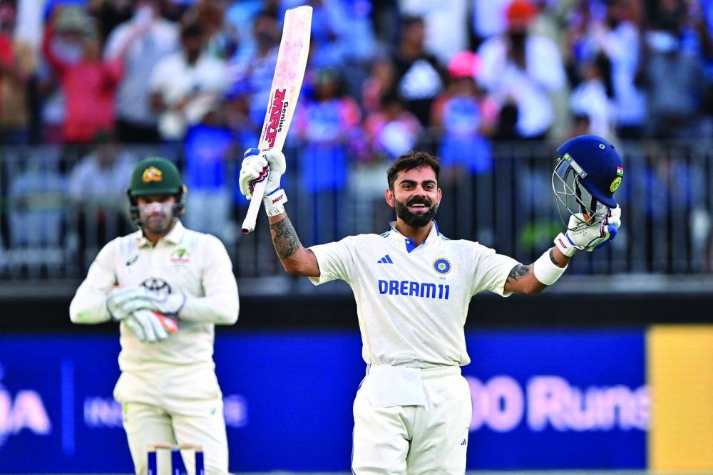India’s Virat Kohli celebrates reaching his century during day three of the first Test against Australia at Optus Stadium in Perth on Sunday. (AFP)