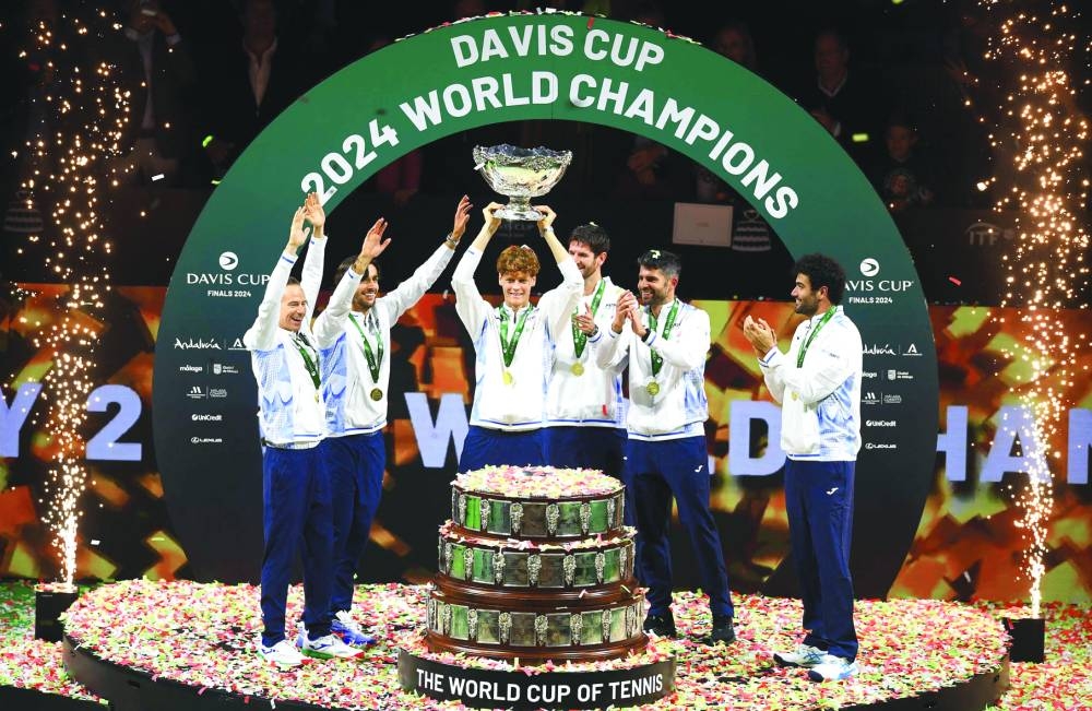 Italy’s Jannik Sinner raises the trophy with teammates after winning the Davis Cup Finals at the Palacio de Deportes Jose Maria Martin Carpena arena in Malaga, southern Spain, on Sunday. (AFP)