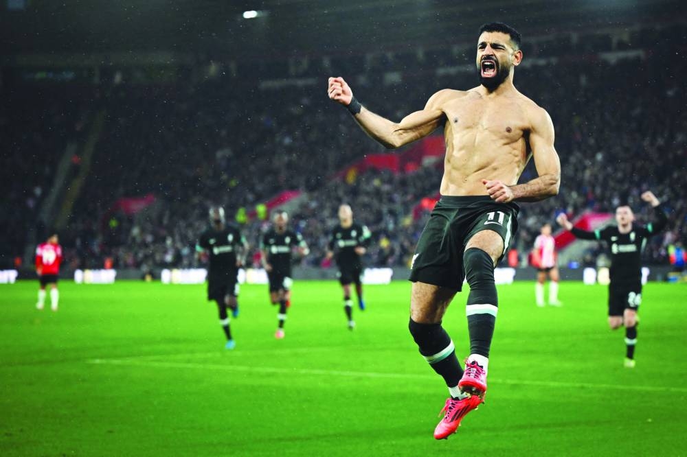 Liverpool’s striker Mohamed Salah celebrates after scoring his team’s third goal during the English Premier League match against Southampton at St Mary’s Stadium in Southampton on Sunday. (AFP)