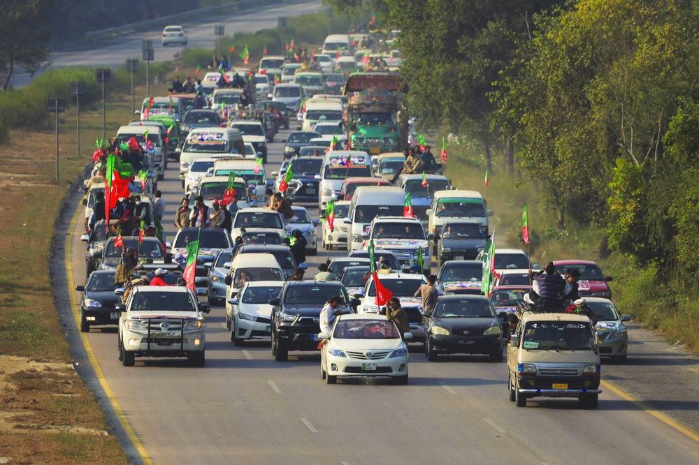 A convoy by supporters of the former Pakistani PM Imran Khan’s party Pakistan Tehreek-e-Insaf heads towards Islamabad, during an anti-government rally, in Peshawar, on Sunday. ((Reuters)