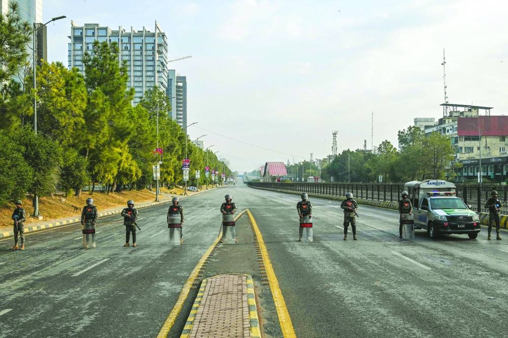 Paramilitary soldiers stand guard at a blocked road leading towards the Red Zone area in the federal capital. (AFP)