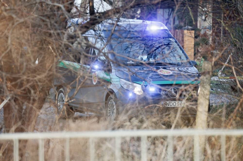 A rescue vehicle stands near the cordoned-off area where a DHL cargo plane crashed near the Vilnius International Airport in Vilnius, on Monday. AFP
