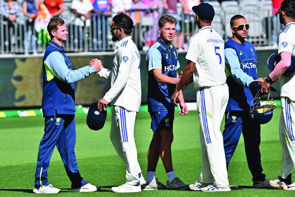India’s Virat Kohli (second right) shakes hands with Australia’s Steve Smith at the end of the first Test on Monday. (AFP)
