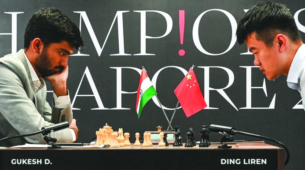 China’s grandmaster Ding Liren and India’s grandmaster Gukesh Dommaraju compete during the start of the FIDE World Chess Championship in Singapore on Monday. (AFP)