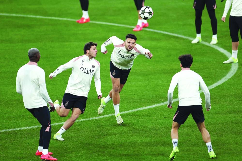 PSG’s midfielder Joao Pedro Goncalves Neves (second from left) and forward Goncalo Ramos (second right) eye the ball during a training session on the eve of the UEFA Champions League match against FC Bayern Munich at the Allianz Arena in Munich on Monday. (AFP)