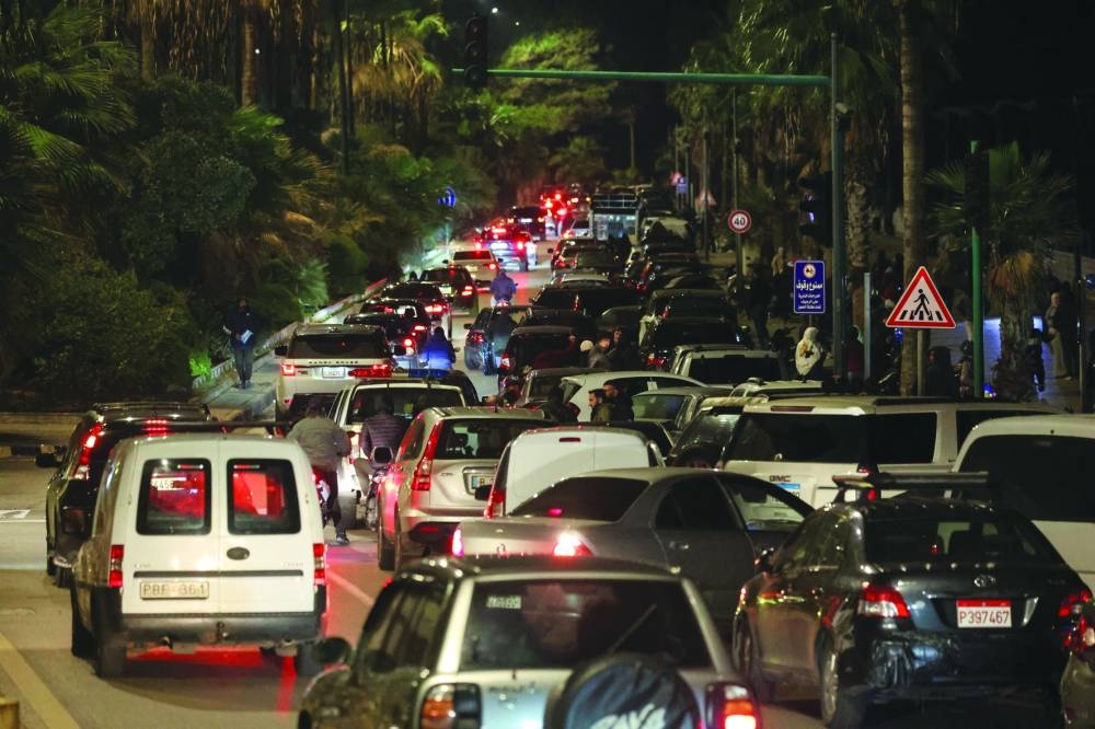 Cars drive in traffic as people leave after Israeli evactuation orders, at Beirut's seaside Corniche, Tuesday.