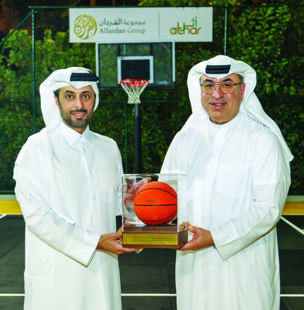 Omar Hussain Alfardan, the president and CEO of Alfardan Group, handing over a ceremonial token to the minister.