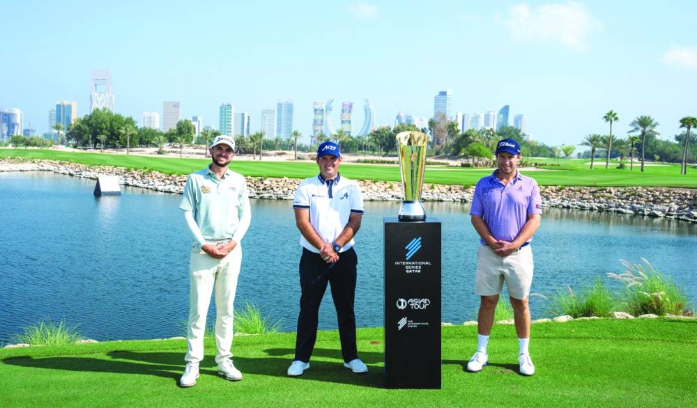 Golfers Patrick Reed (centre), Ben Campbell (right) and John Catlin pose with the International Series Qatar trophy at the Doha Golf Club on Tuesday.