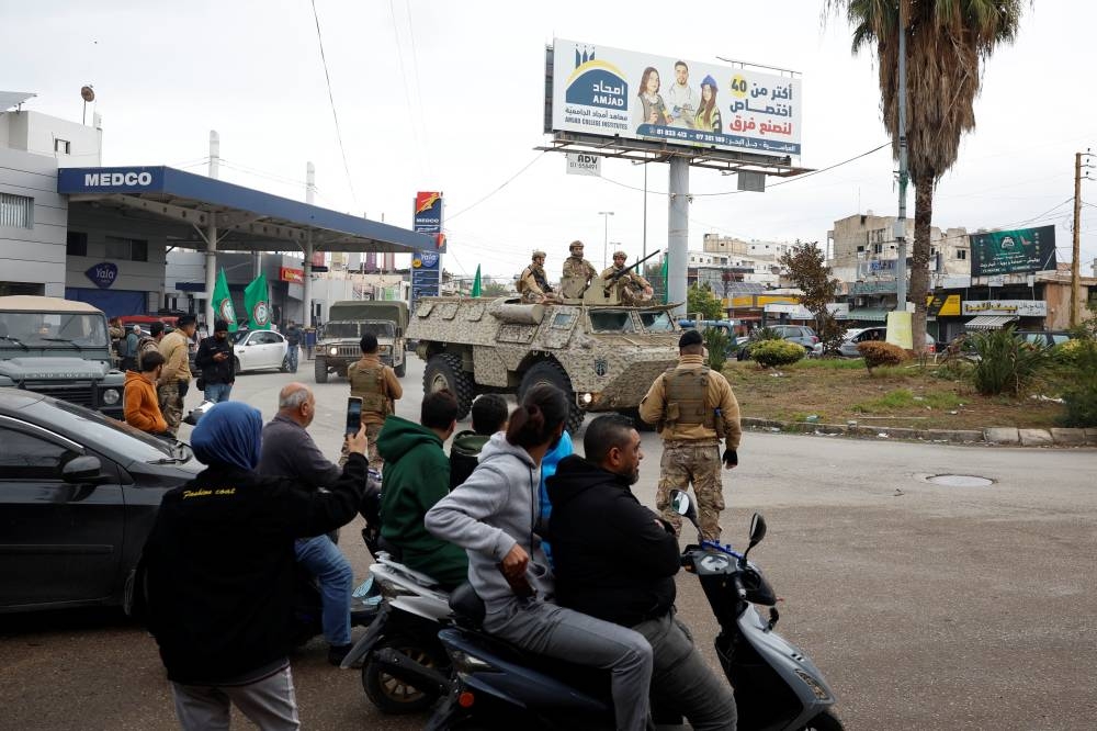 Lebanese soldiers ride a vehicle as they arrive to Tyre, Lebanon, on Wednesday. REUTERS