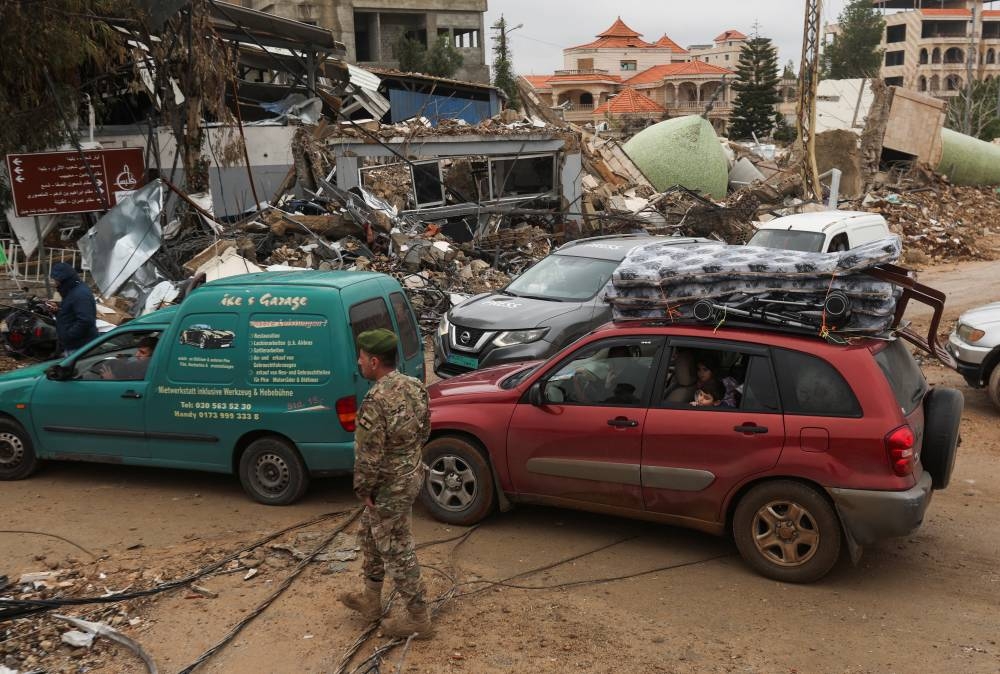 Displaced people return back to Bent Jbeil in cars, southern Lebanon, on Wednesday. REUTERS