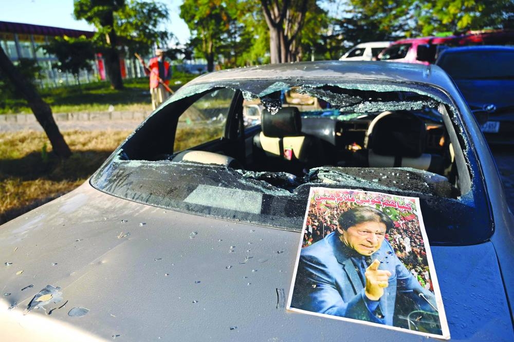  Below: A poster of Khan is pictured on a damaged vehicle. (AFP)