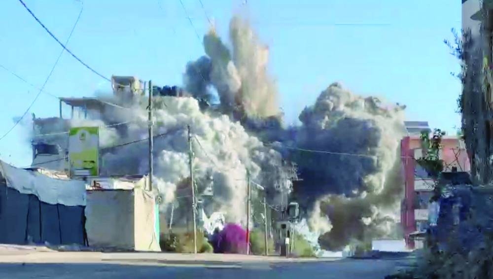 Smoke billows from a residential building hit by an Israeli strike, in Nuseirat refugee camp, in the central Gaza Strip, on Thursday 
