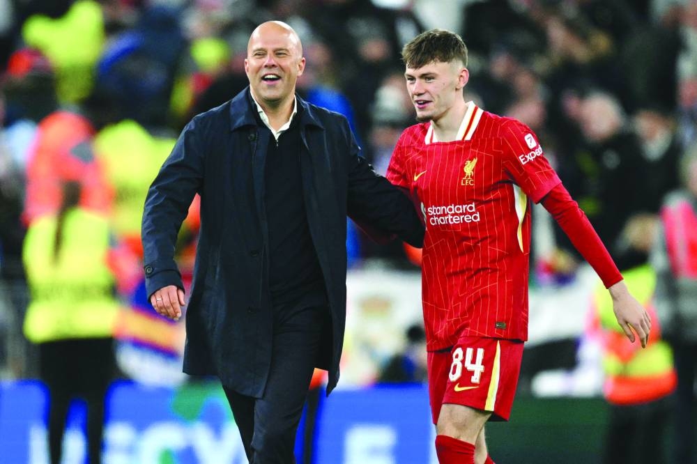 
Liverpool manager Arne Slot and defender Conor Bradley celebrate after the UEFA Champions League match against Real Madrid at Anfield in Liverpool. Liverpool won 2-0. (AFP) 