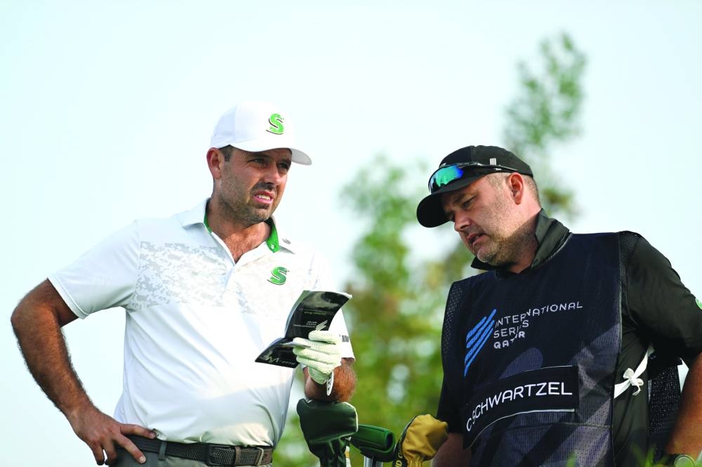 South Africa’s Charl Schwartzel with his caddie during the round two of the International Series Qatar at the Doha Golf Club on Thursday.