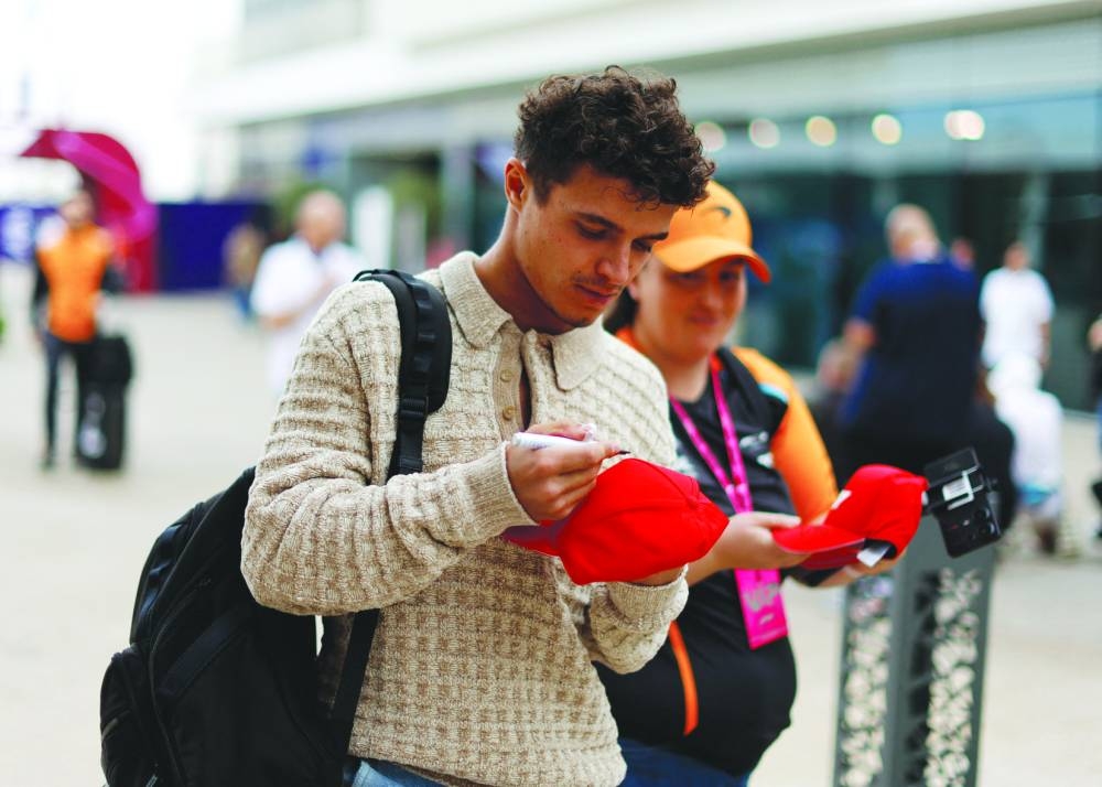 From Left: McLaren’s Lando Norris, Ferrari’s Carlos Sainz Jr and Charles Leclerc arrive at the Lusail International Circuit on Thursday. (Reuters)