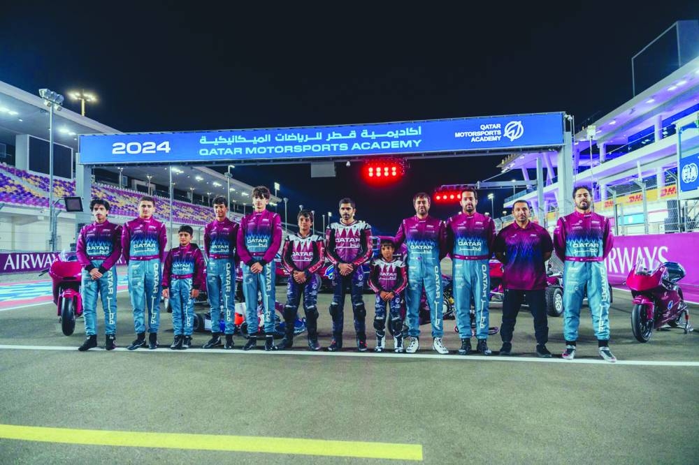 
Qatar drivers and riders pose at the Lusail International Circuit.
 