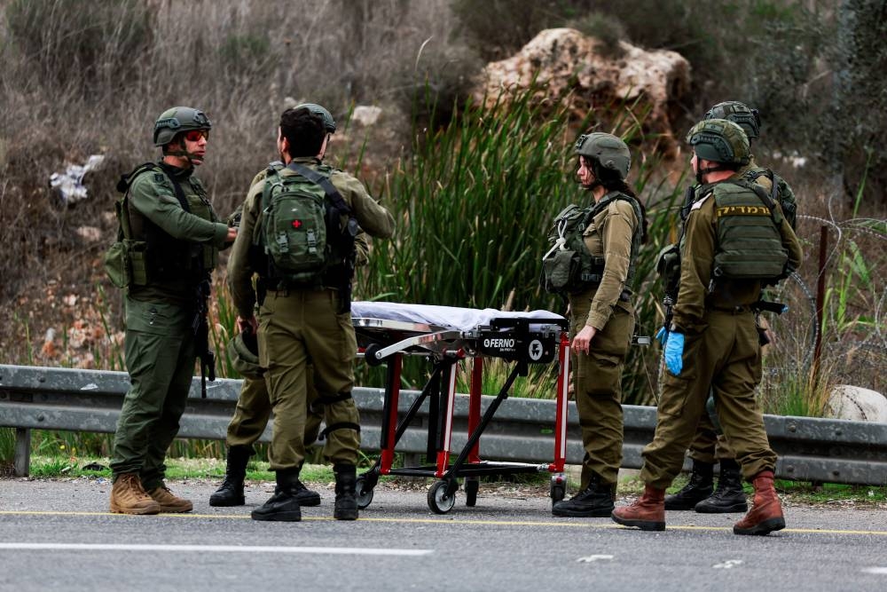 Israeli security forces members work at the scene of a shooting attack near the Jewish settlement of Ariel, in the Israeli-occupied West Bank, Friday. REUTERS