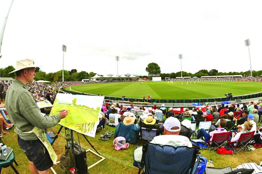 British artist Andy Brown draws the ground during the second day of the first Test between New Zealand and England in Christchurch on Friday. (AFP)