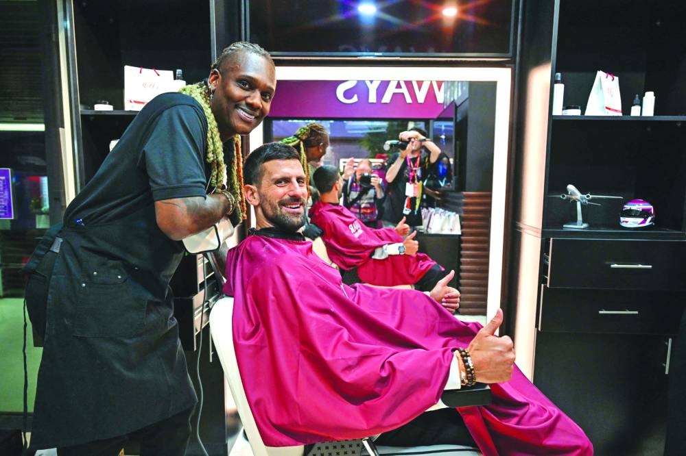 Novak Djokovic sits for a beard trimming at Lusail International Circuit in Lusail in Qatar on Friday. (AFP)