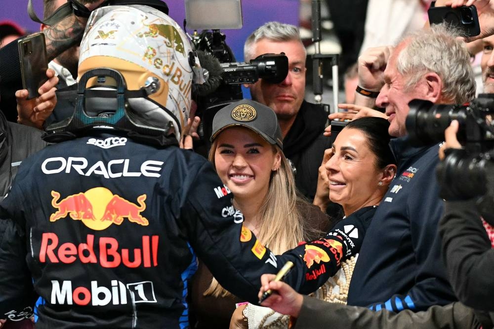Red Bull Racing's Dutch driver Max Verstappen celebrates with sister and mother at parc ferme after winning the Qatari Formula One Grand Prix. AFP