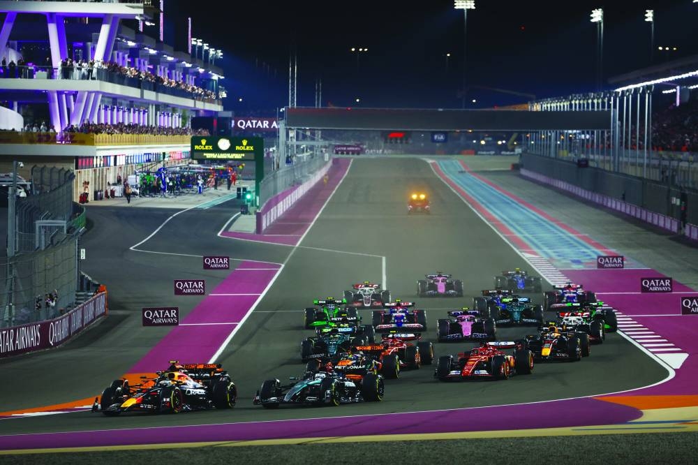 George Russell, Mercedes F1 W15, leads Max Verstappen, Red Bull Racing RB20, Lando Norris, McLaren MCL38, Oscar Piastri, McLaren MCL38, and the rest of the field at the start
