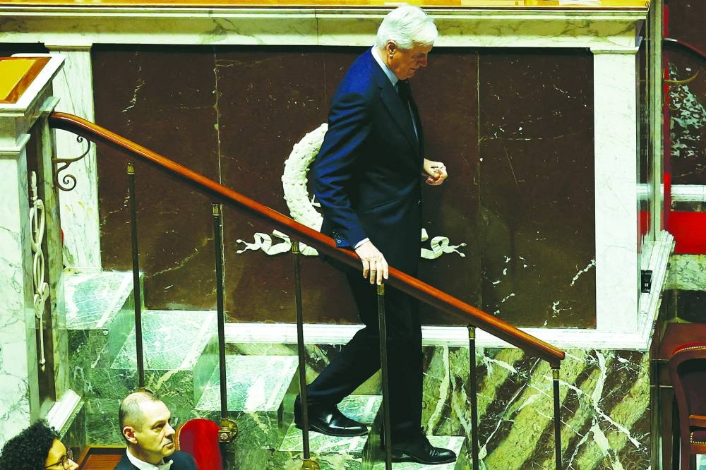 French PM Michel Barnier leaves after he delivered a speech to announce the use of Article 49.3 to push the budget bill through the National Assembly without a vote by lawmakers in Paris on Monday. (Reuters)