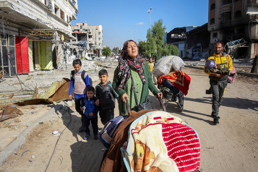Displaced Palestinians make their way as they flee the northern part of Gaza, in Jabalia in the northern Gaza Strip, on Wednesday. REUTERS
