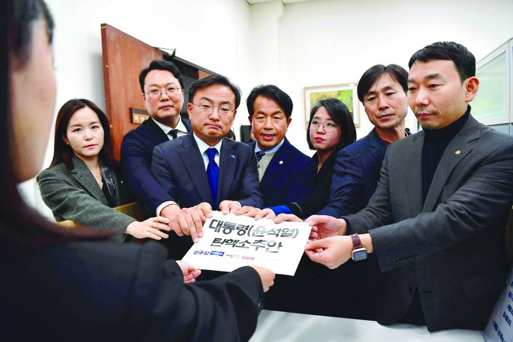 
Opposition leaders submit an impeachment motion against South Korea President Yoon Suk-yeol at the National Assembly in Seoul. (AFP) 