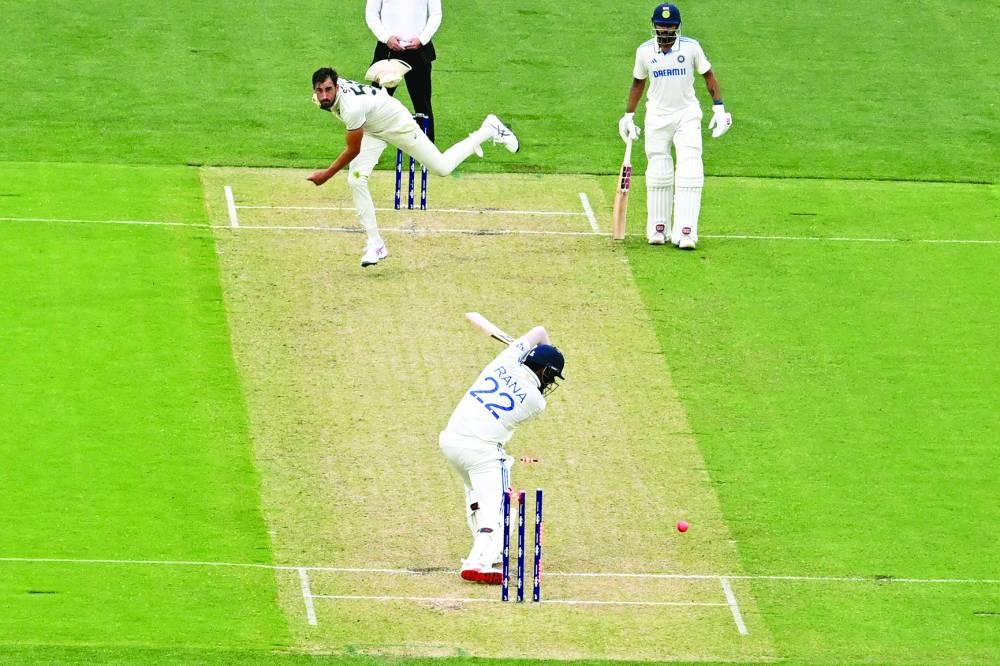 Australia’s Mitchell Starc (left) bowls Indian batsman Harshit Rana on the first day of the second Test at the Adelaide Oval on Friday. (AFP)