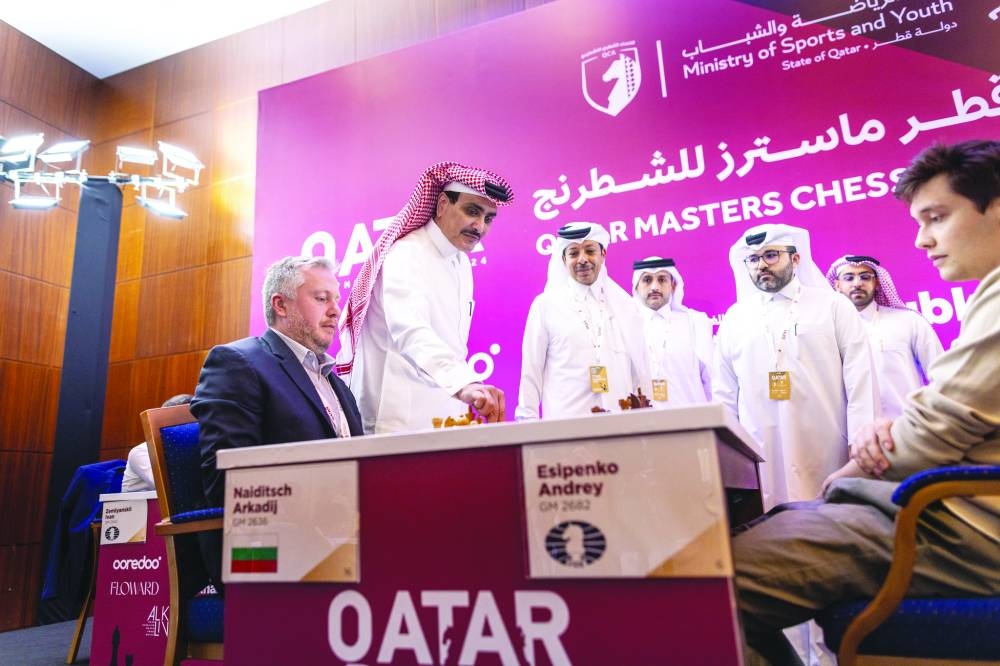 HE Sheikh Saud bin Khalid bin Hamad al-Thani makes the ceremonial starting move in the game between Russia’s Andrey Esipenko and Arkadij Naiditsch of Bulgaria at the Qatar Masters at Aspire Zone on Friday.