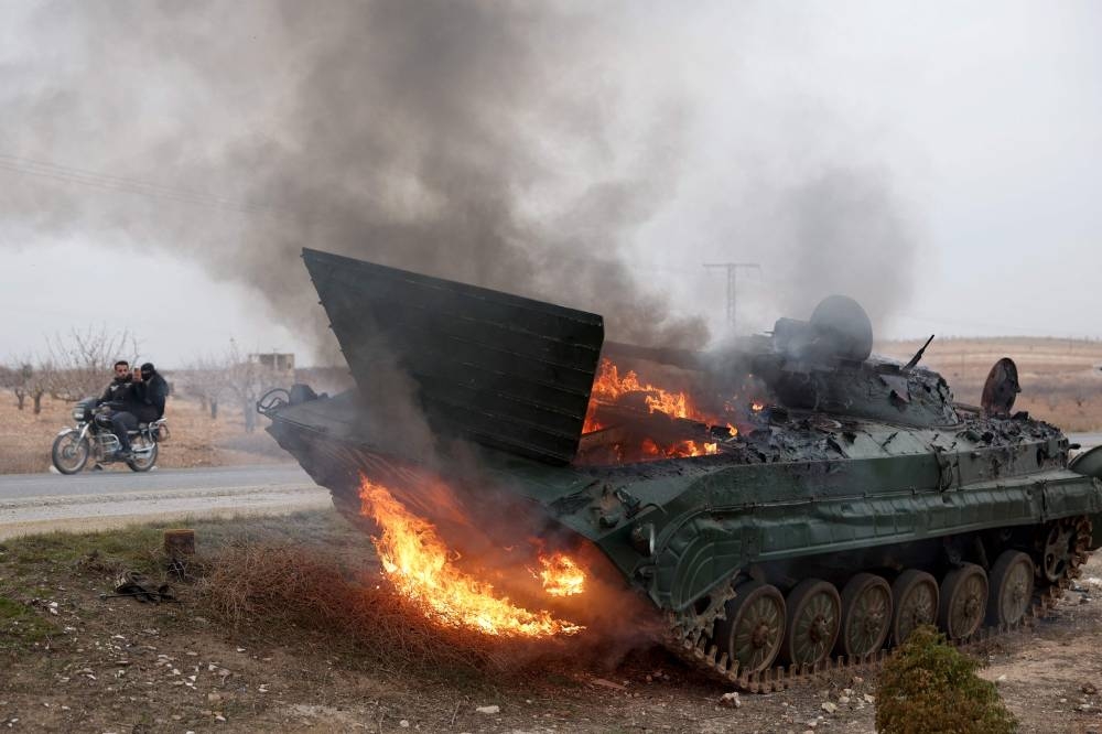 A military vehicle belonging to the Syrian regime forces and seized by anti government forces burn after it was hit by regime forces in the Hama governorate, on Saturday. AFP
