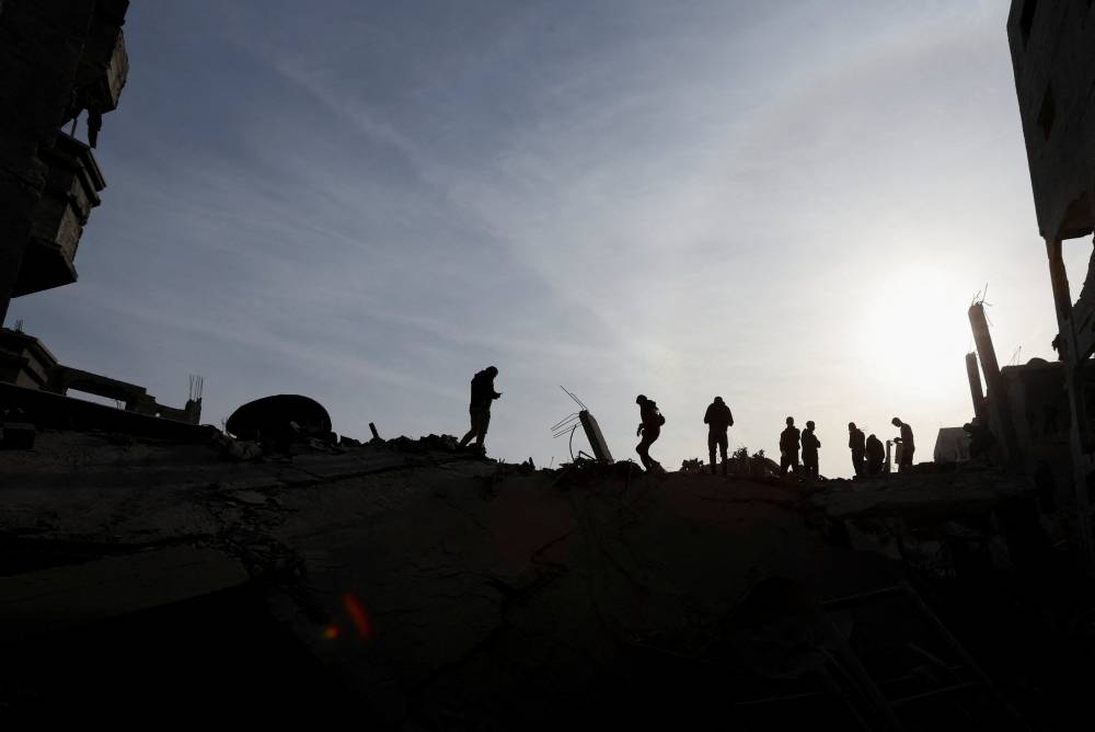 Palestinians inspect damage at the site of an Israeli strike on a house at the Nuseirat refugee camp in the central Gaza Strip, on Saturday. REUTERS