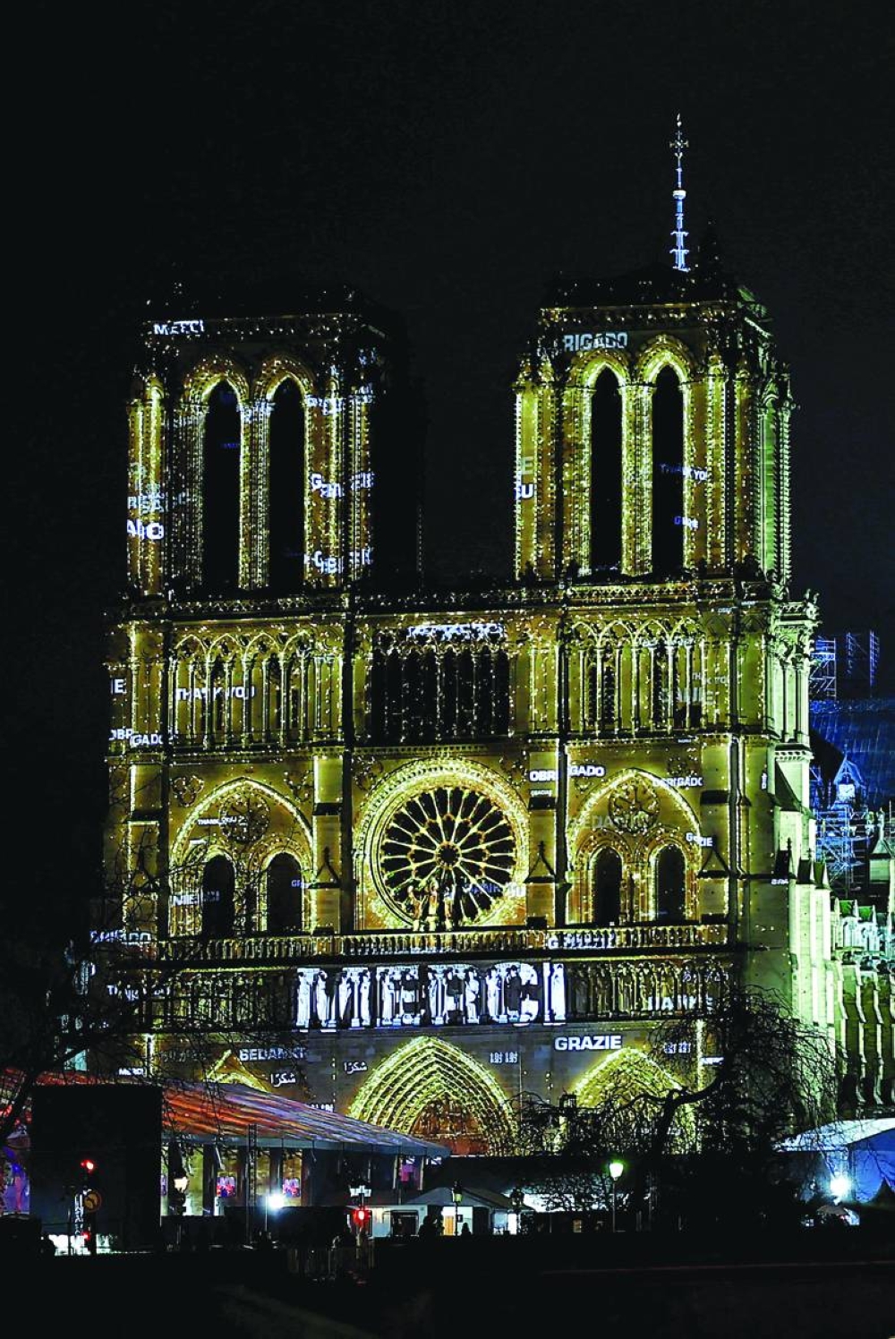 
The word “Thank you” is seen on the facade of the Notre-Dame de Paris Cathedral during a light show for its reopening service ceremony in Paris yesterday. (Reuters) 