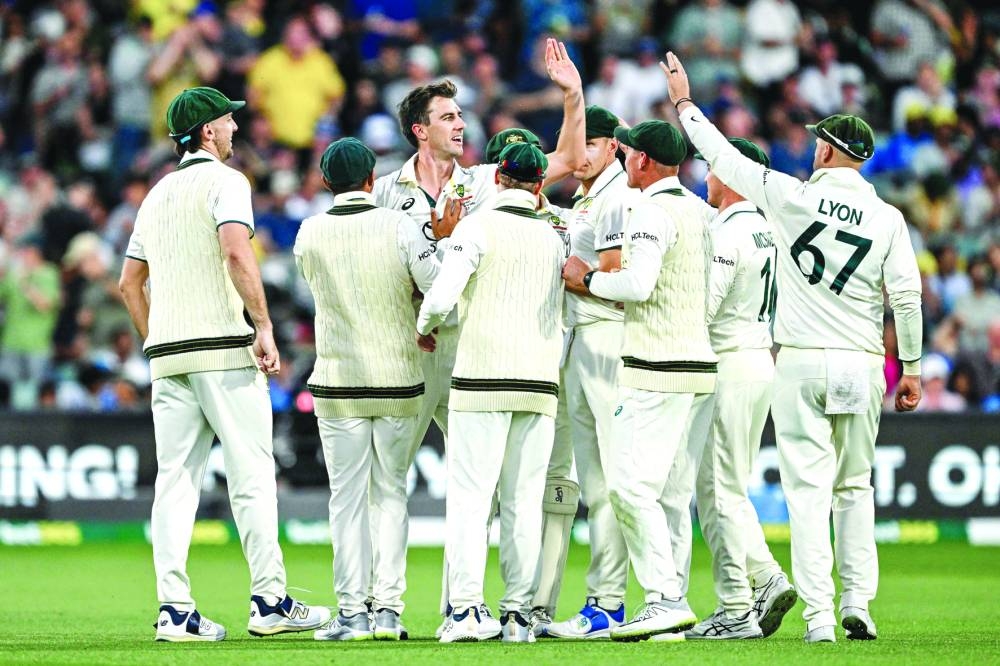 Australian captain Pat Cummins (third from left) celebrates with teammates after taking the wicket of India’s KL Rahul in Adelaide on Saturday. (AFP)