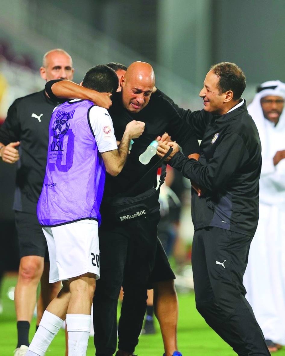 Am emotional Al Khor coach Mehdi Nafti hugs his players after his side’s win over Al Duhail in the Qatar Stars League at the Abdullah Bin Khalifa Stadium on Saturday.