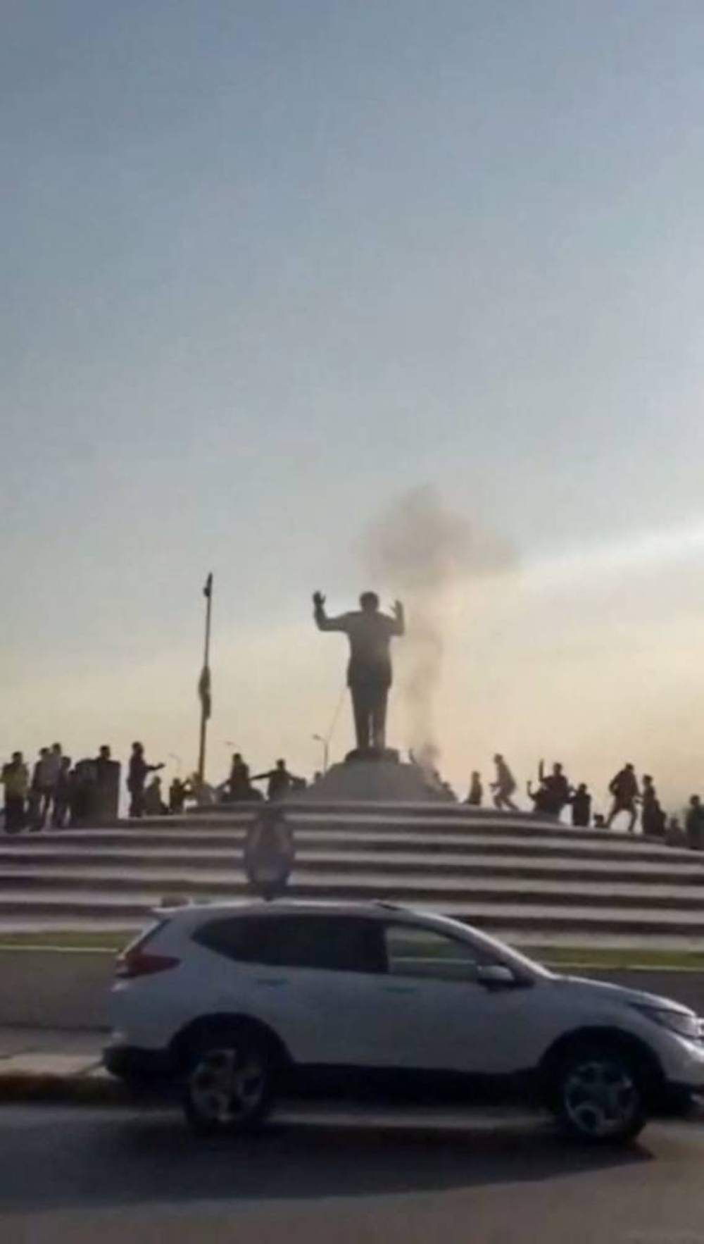 People topple a statue of Syria's Bashar al-Assad, after Syrian rebels announced that they have ousted him, in Tartus, Syria, on Sunday. REUTERS