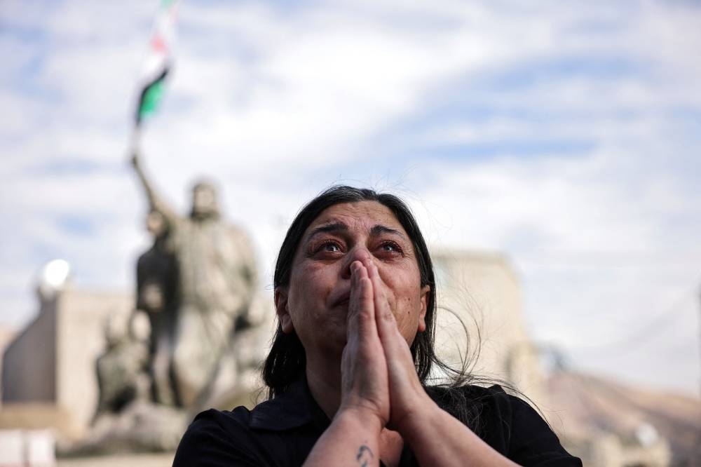 A woman reacts, as people celebrate after Syrian rebels announced that they have ousted President Bashar al-Assad, in Majdal Shams, a Druze village in the Israeli-occupied Golan Heights, on Sunday. REUTERS