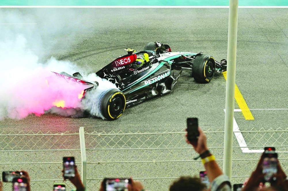 
British driver Lewis Hamilton performs a burn out after the Abu Dhabi Formula One Grand Prix yesterday. (AFP) 
