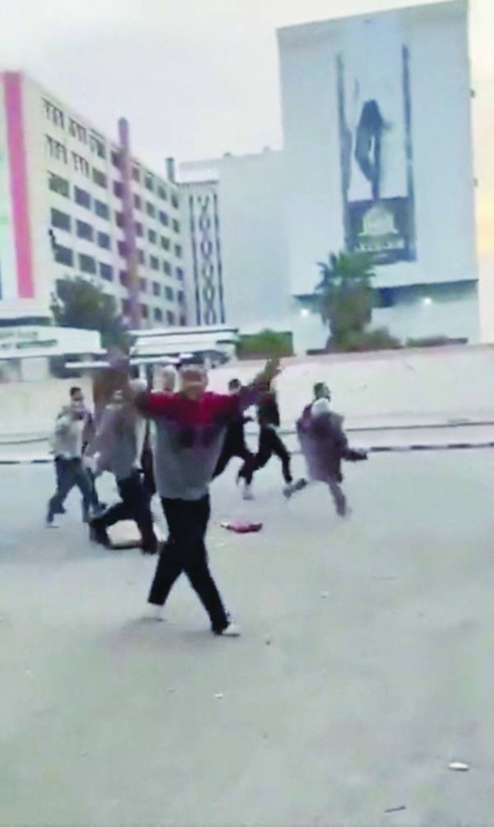 A person gestures as individuals — reportedly freed prisoners — run in the streets of Damascus yesterday in this picture obtained from social media video. (Reuters) 