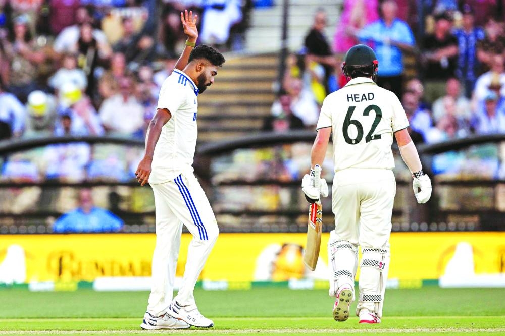 
India’s Mohammed Siraj reacts after taking the wicket of Australia’s Travis Head (right) in Adelaide on Saturday. (AFP) 